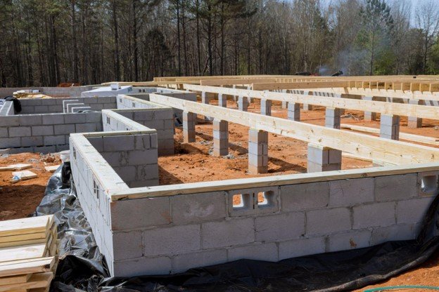 Concrete block foundation with floor framing system installed during new home construction in Chagrin Falls, OH