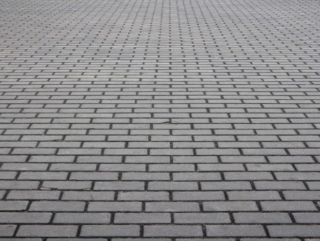 Gray brick paver driveway installed in a running bond pattern for residential property in Chagrin Falls, OH